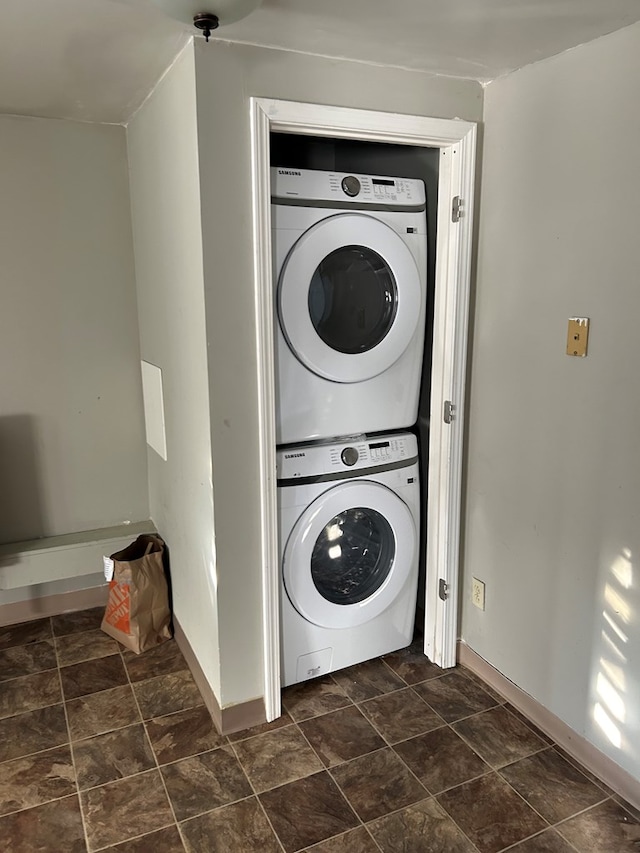 laundry room featuring stacked washer / drying machine