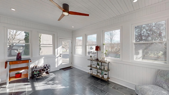 sunroom with plenty of natural light, wooden ceiling, and ceiling fan