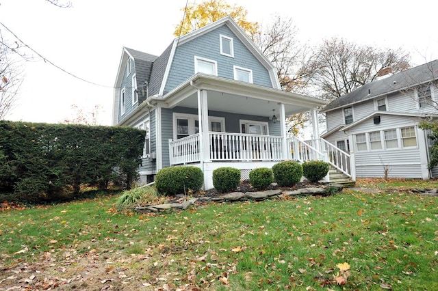 view of front facade with a front lawn and a porch