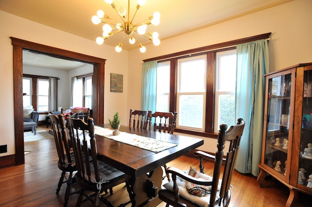 dining space featuring dark hardwood / wood-style floors and a notable chandelier