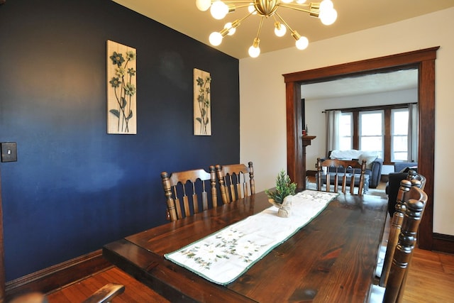 dining area featuring hardwood / wood-style floors and a chandelier