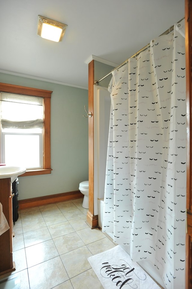 full bathroom with tile patterned floors, ornamental molding, vanity, shower / bath combo with shower curtain, and toilet