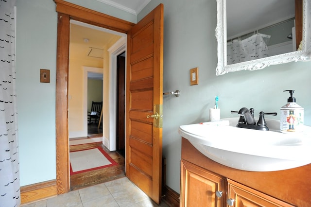 bathroom with tile patterned flooring, vanity, a shower with shower curtain, and crown molding