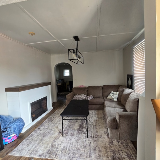 living room with hardwood / wood-style flooring and crown molding