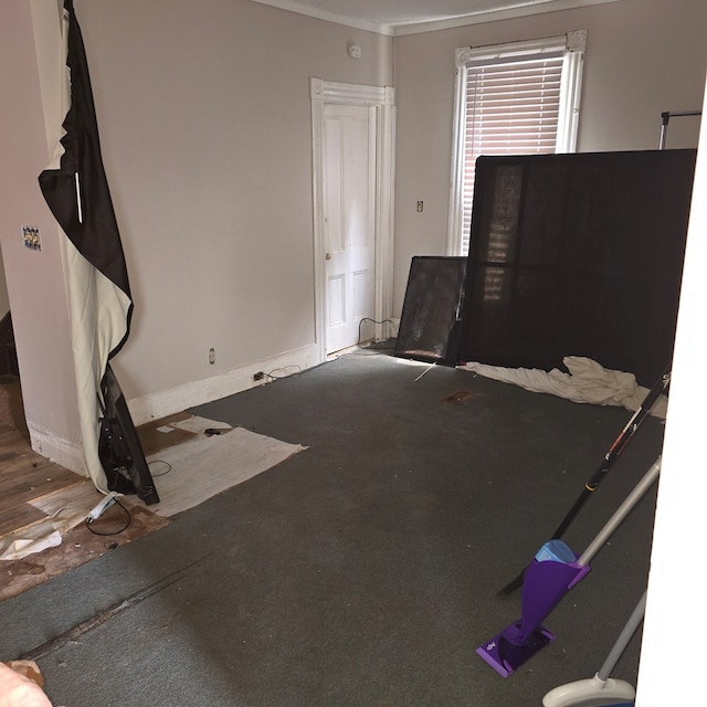 unfurnished living room with wood-type flooring and ornamental molding