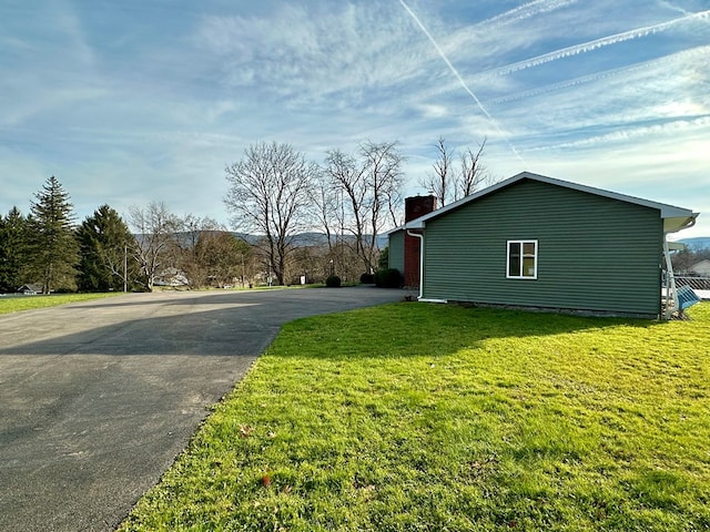 view of side of home featuring a yard