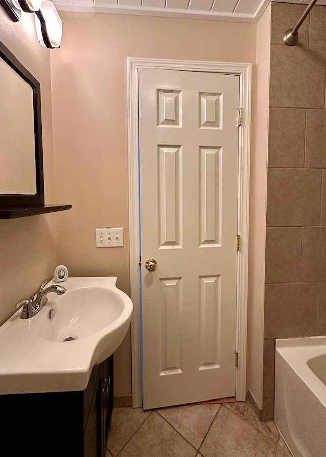 bathroom with vanity, tile patterned flooring, and tiled shower / bath combo