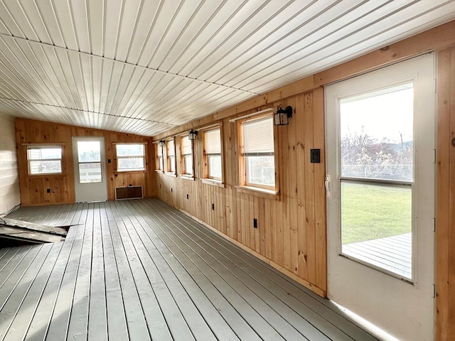 unfurnished sunroom featuring a wealth of natural light and vaulted ceiling