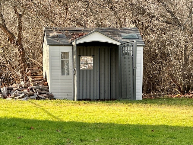 view of outbuilding with a yard