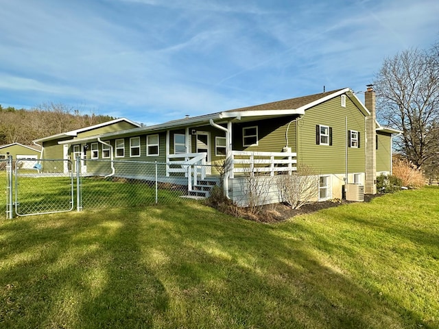 view of front of house featuring a front yard and central air condition unit