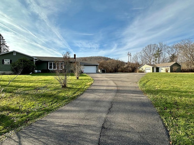 view of front of house featuring a garage and a front lawn