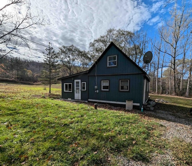 rear view of house featuring a lawn