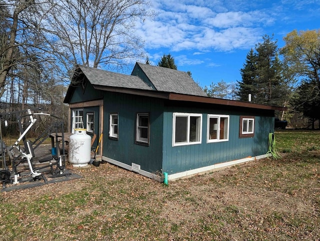 view of side of home featuring an outbuilding