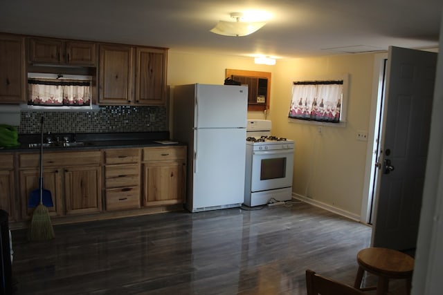 kitchen with sink, white appliances, dark hardwood / wood-style floors, and backsplash