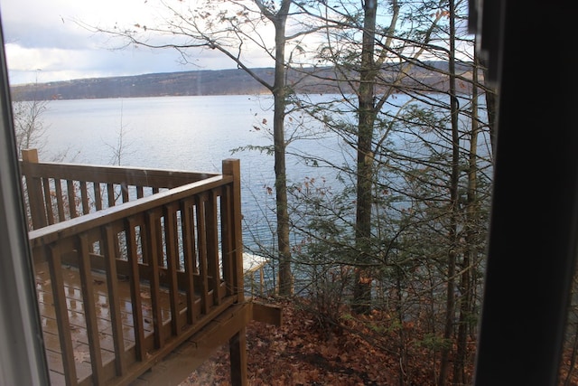 wooden terrace featuring a water view