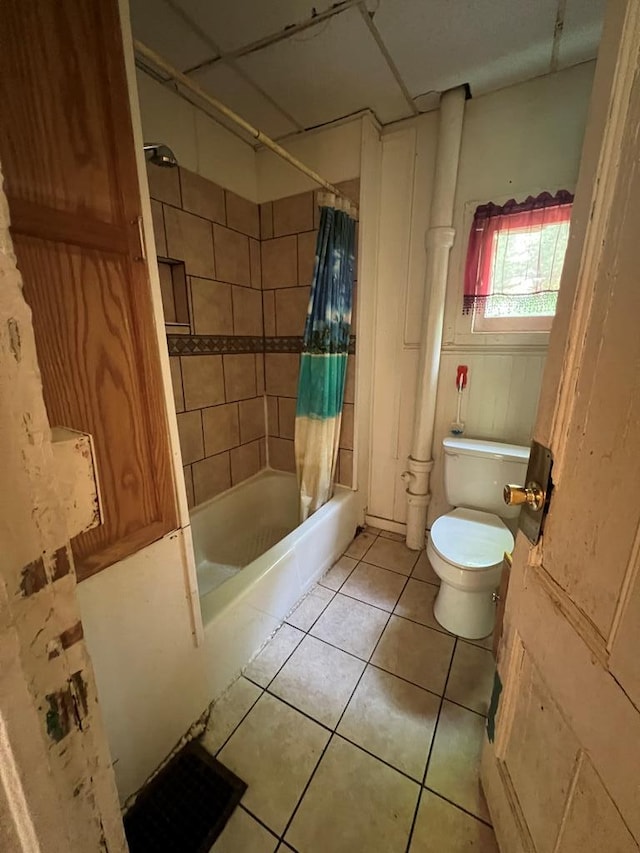 bathroom featuring shower / bath combination with curtain, toilet, and tile patterned flooring