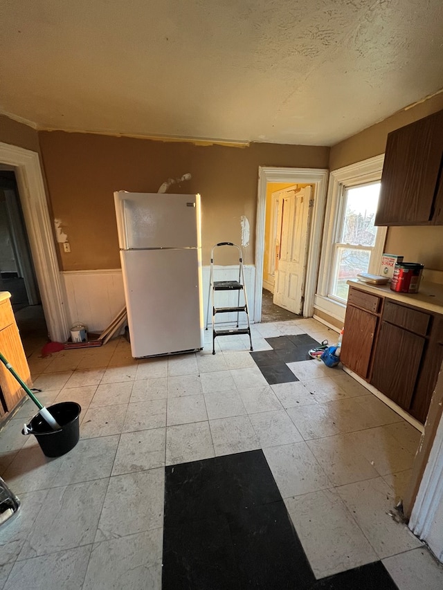 kitchen with a textured ceiling and white fridge