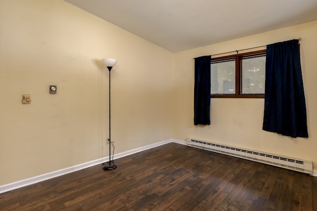 unfurnished room featuring dark hardwood / wood-style flooring and a baseboard radiator