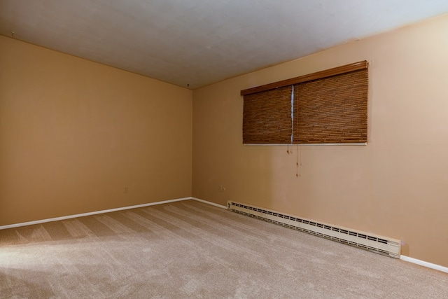 carpeted spare room with a baseboard radiator