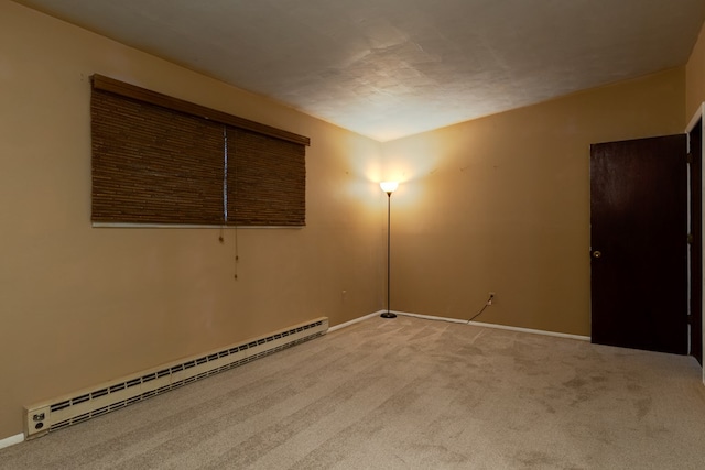 unfurnished room with light colored carpet and a baseboard radiator