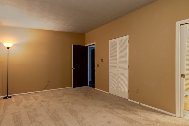 unfurnished bedroom featuring light carpet