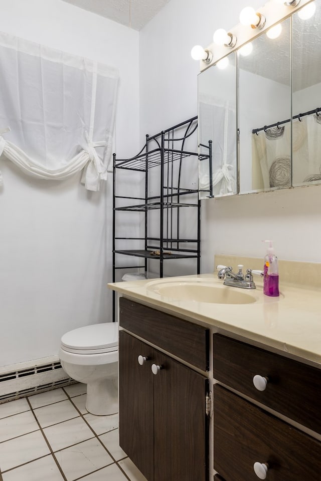 bathroom with a textured ceiling, vanity, a baseboard heating unit, tile patterned flooring, and toilet