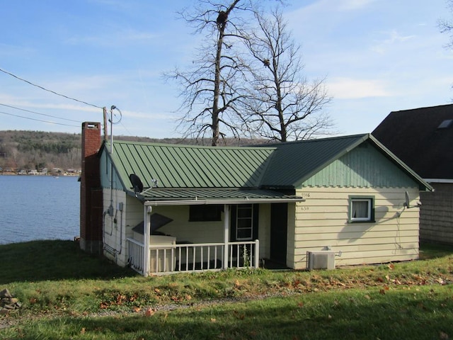 back of house with a water view and central AC unit