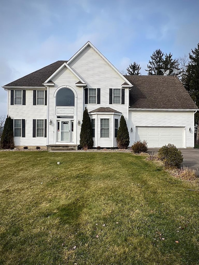 view of front of home with a garage and a front lawn