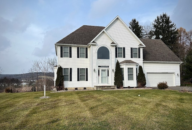 view of front of property with a garage and a front lawn