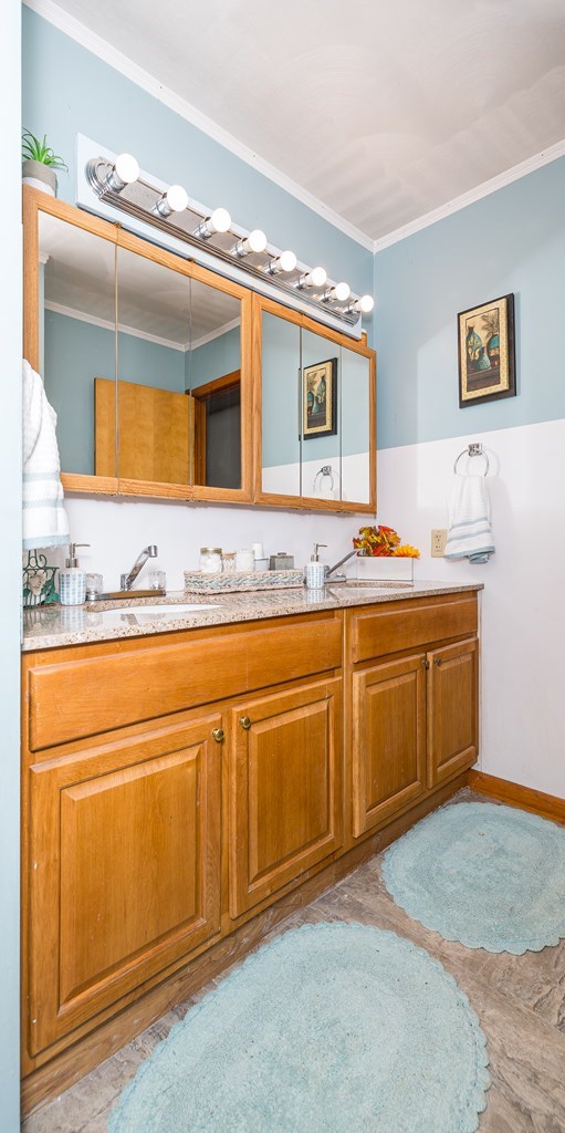 bathroom featuring vanity and ornamental molding