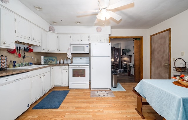 kitchen with white appliances, sink, ceiling fan, light wood-type flooring, and white cabinetry