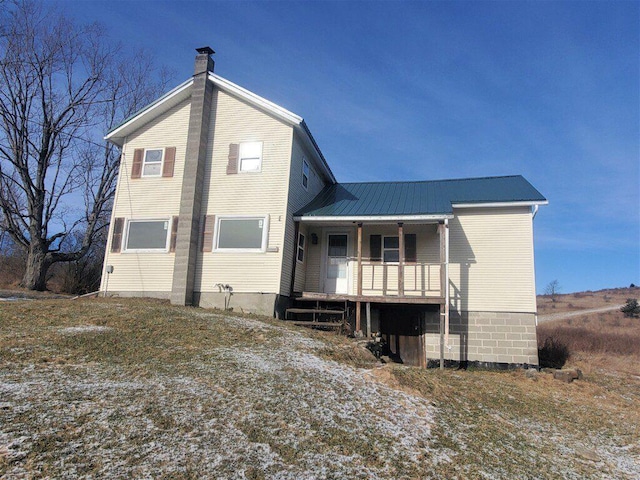 rear view of property with a porch