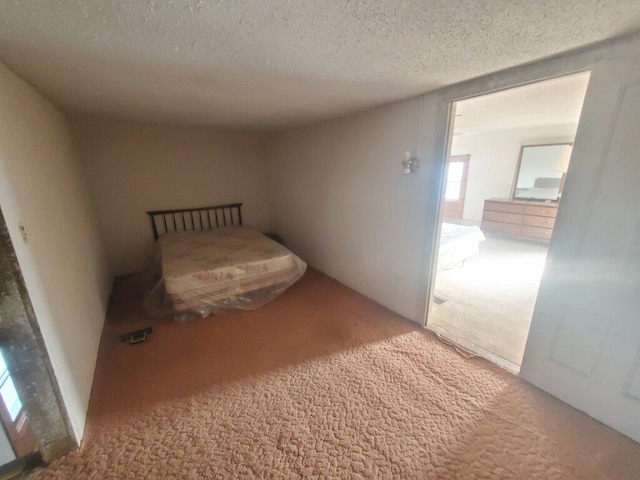 unfurnished bedroom featuring carpet floors and a textured ceiling