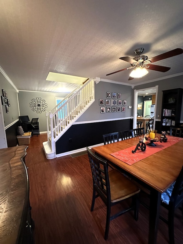 dining room with a textured ceiling, ceiling fan, crown molding, and dark hardwood / wood-style floors