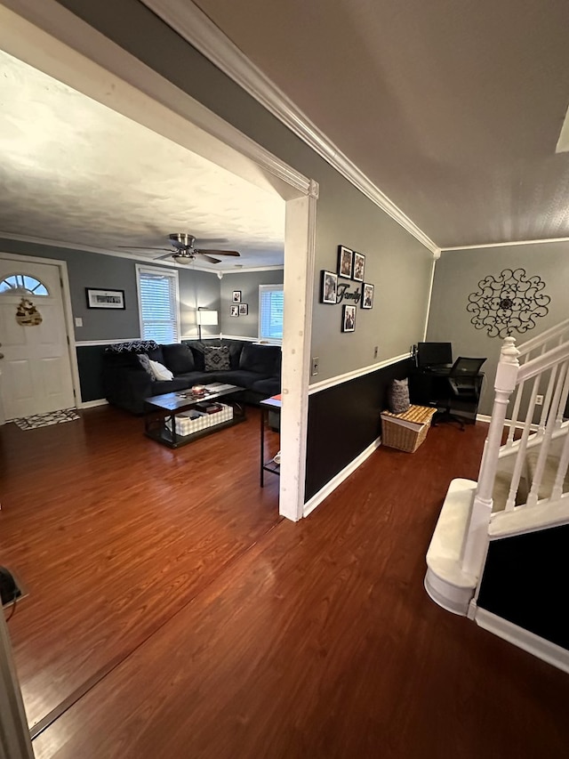 living room featuring hardwood / wood-style flooring, ceiling fan, ornamental molding, and lofted ceiling