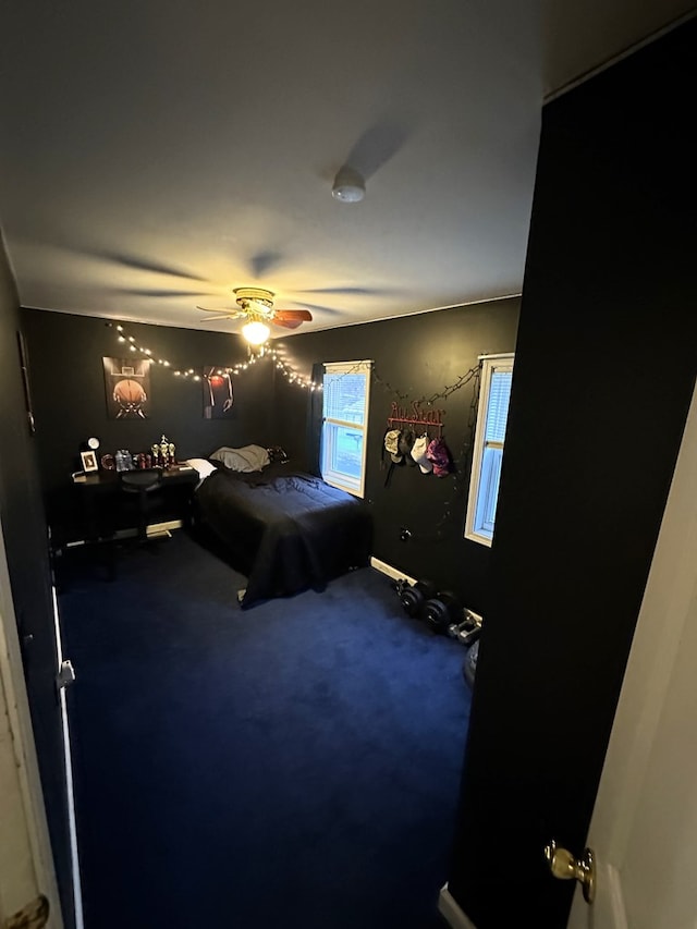 bedroom with ceiling fan and carpet floors