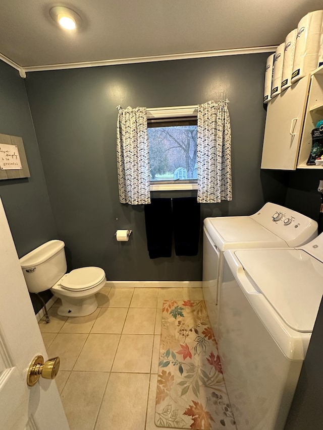 washroom with washing machine and dryer, light tile patterned floors, and ornamental molding