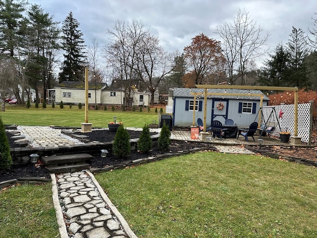 view of yard featuring an outbuilding and a patio