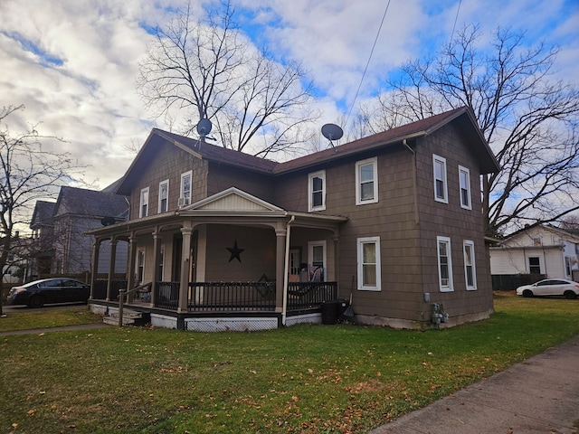 view of front of home featuring covered porch and a front yard