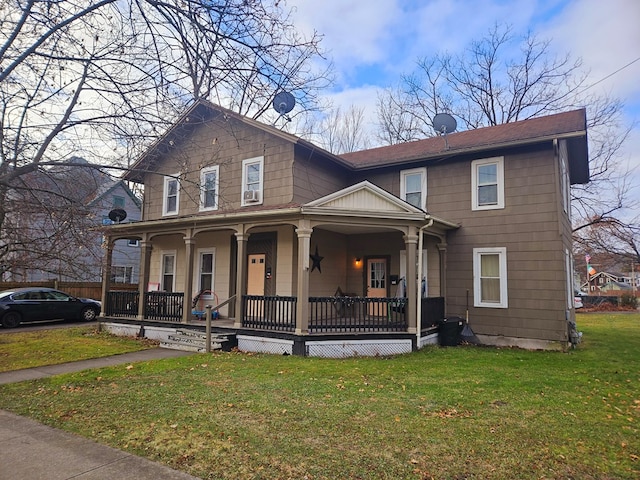 view of front of house with a porch and a front yard