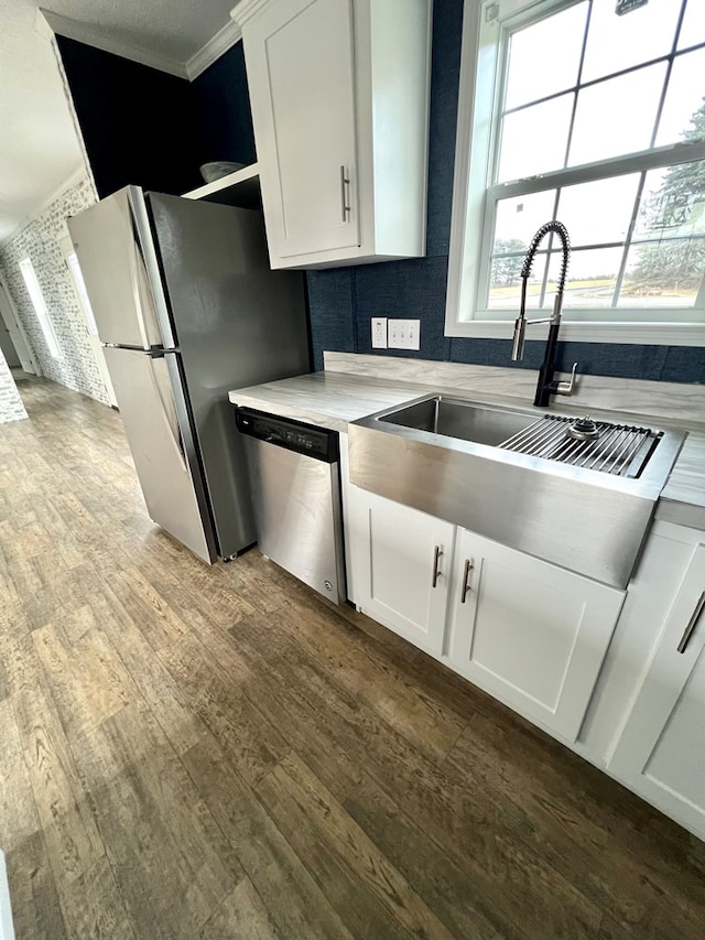 kitchen with dark hardwood / wood-style floors, sink, white cabinetry, and stainless steel appliances