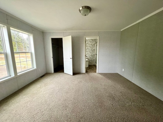 unfurnished bedroom featuring carpet floors and ornamental molding