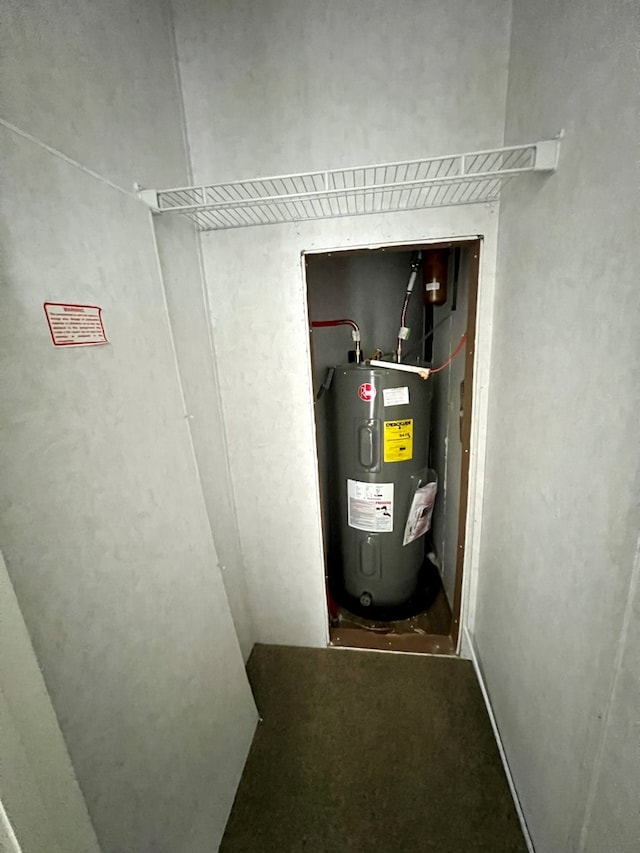 utility room featuring water heater