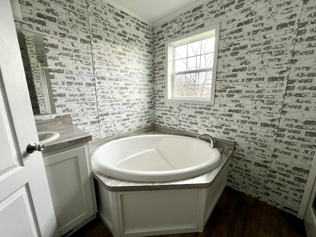 bathroom featuring hardwood / wood-style floors, vanity, and a tub