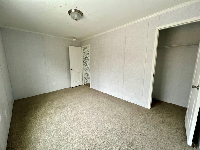 unfurnished bedroom featuring crown molding, a closet, and carpet floors