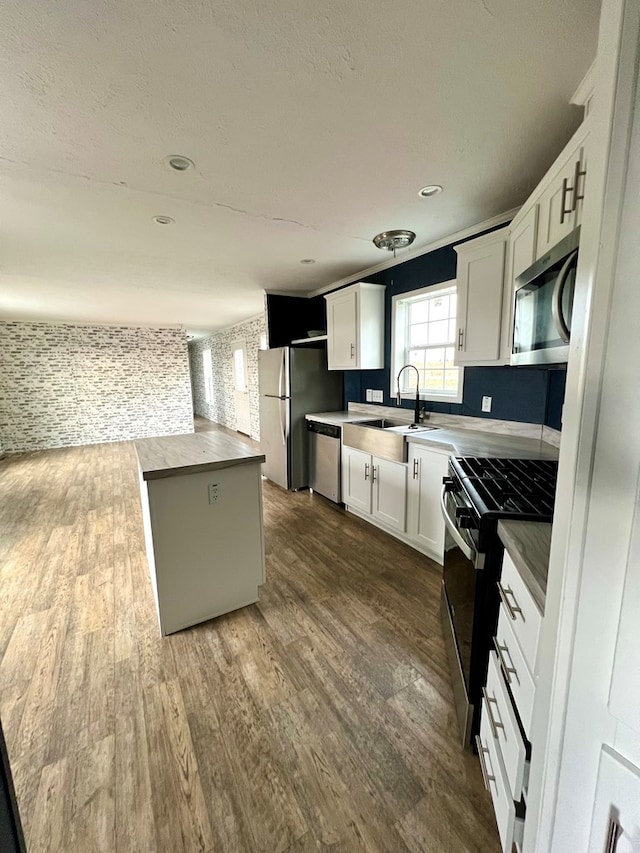 kitchen featuring sink, white cabinets, stainless steel appliances, and dark hardwood / wood-style floors