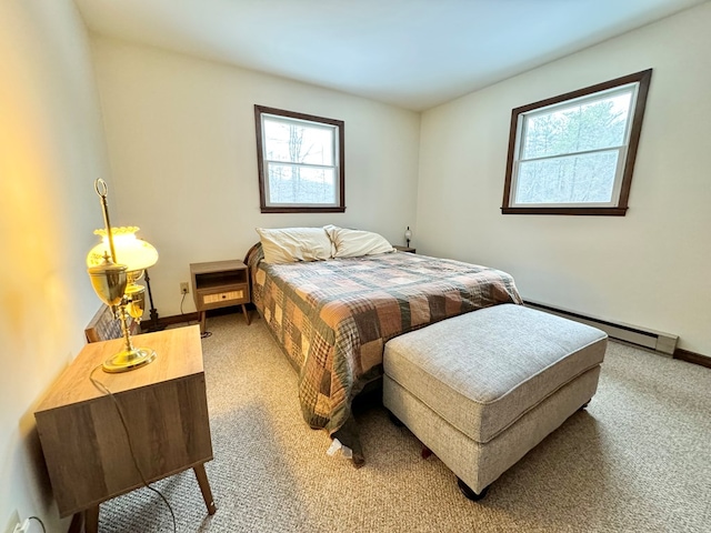 bedroom with baseboard heating, multiple windows, and carpet flooring