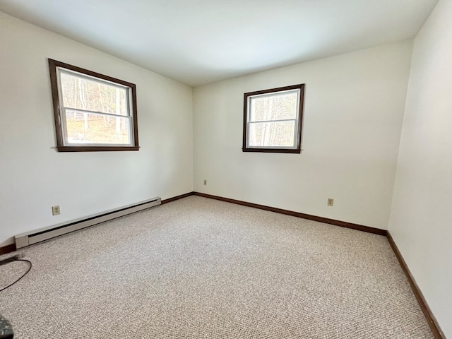 empty room with carpet flooring and a baseboard heating unit