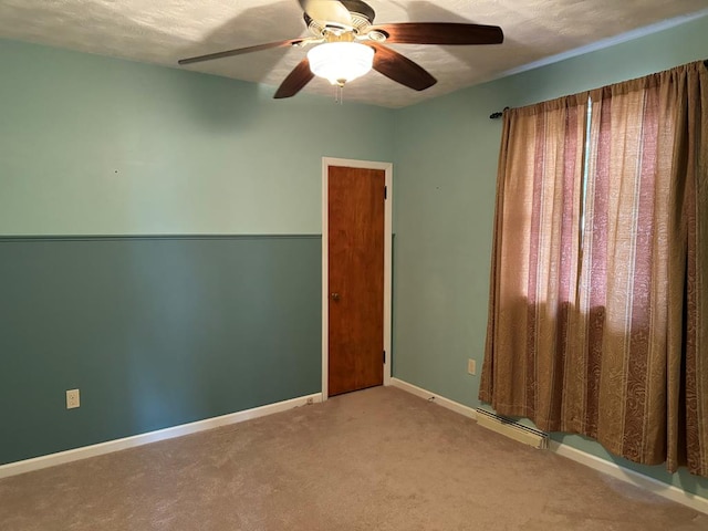 carpeted spare room with a textured ceiling and ceiling fan