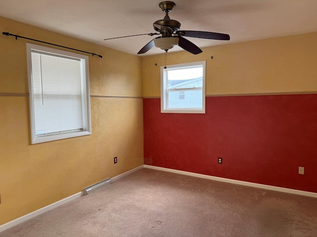 carpeted empty room featuring ceiling fan